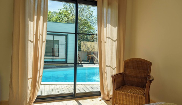 Beautiful renovation of a farmhouse with modern extension, overlooking a swimming pool.