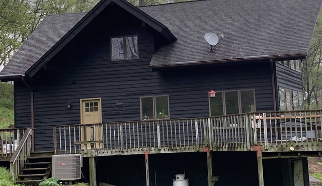 Beautiful unique A frame house on 15ac located directly on a great trout river