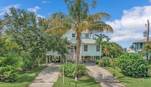 Beautiful waterfront Key West style home with a pool
