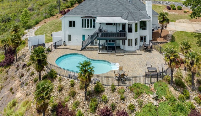 Beautiful Waterfront Home with abundant outdoor seating, pool, hot tub, grill