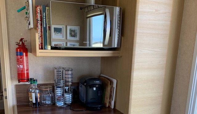 Beautifully decorated caravan right next to the sea with picturesque views