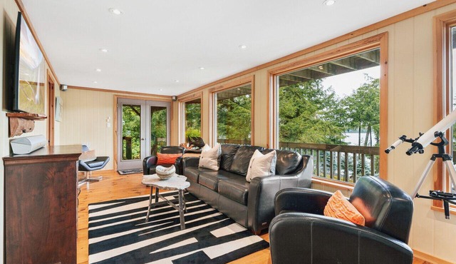 Beautifully landscaped with a sandy beach, outdoor sauna, hot-tub and ample water toys.