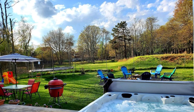 Big house, hot tub, sauna, fireplace trampoline, fire pit.
