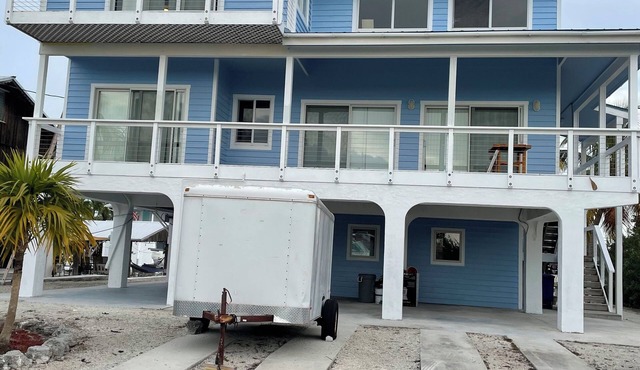 Big Pine House, 4/2 two story, canal access 75 ft dock and stunning Bay view.