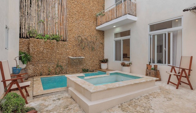 Bohechio studio with private balcony, pool views, ensuite bath, and kitchen.