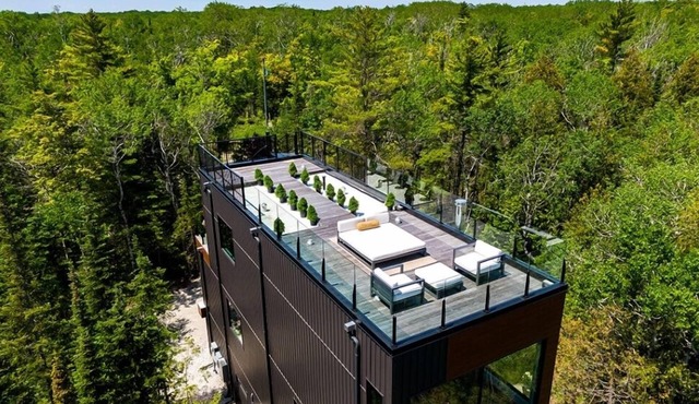 Borchardt Lookout is a modern treetop escape perched above Georgian Bay. Floor-to-ceiling windows, fireplace, open kitchen, spa bath, private deck, and rooftop terrace—set directly on the Bruce Trail.