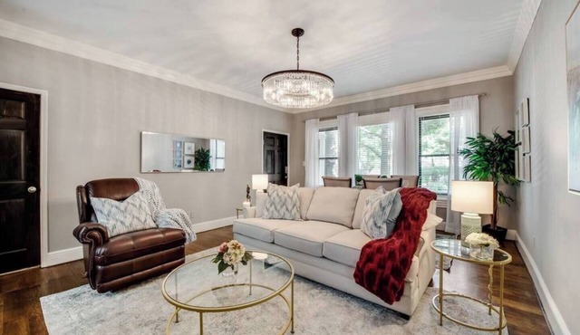Bright 1-bedroom condo combining historic charm with modern comfort. Features a spacious living area with elegant furnishings, crystal lighting, and abundant natural light for a refined Dallas stay.