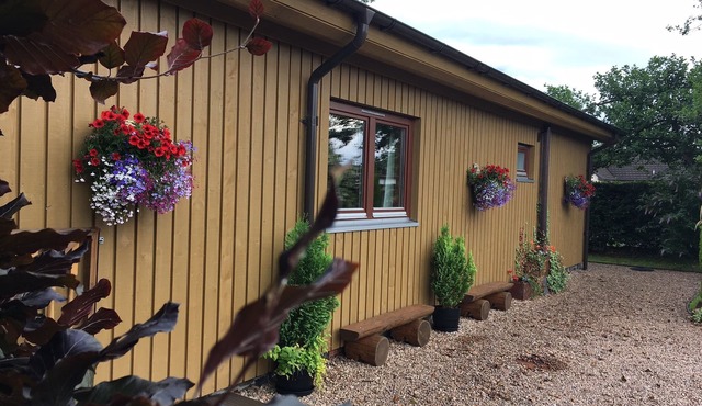 Burnside Lodge, overlooking river Lundy, backdrop of Ben Nevis and Nevis Range.