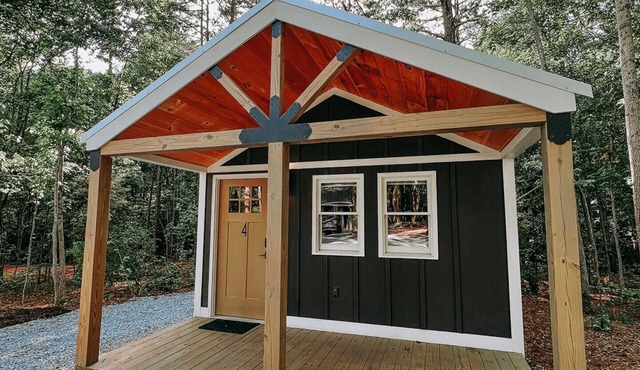 Cabin #4: Two queen-size beds with a kitchenette and a large gravel parking pad beside the cabin for easy boat or trailer storage.