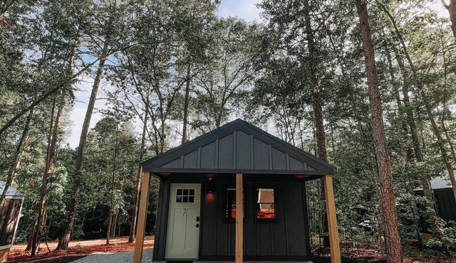 Cabin #7: One king-size bed, a kitchenette, and a large gravel parking pad beside the cabin for easy boat or trailer storage.