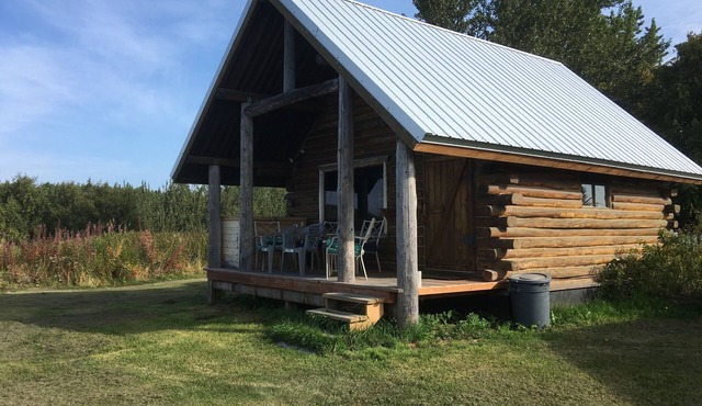 CABIN BY THE BLUFF OF KENAI RIVER WITH MOUNTAIN VIEW