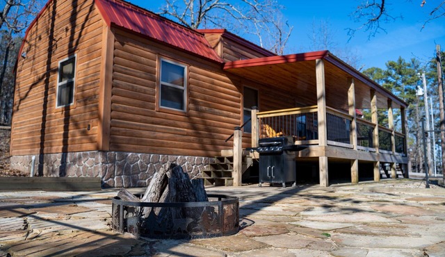 Cabin featuring a vaulted ceiling, a large porch, and huge patio with fire pit.