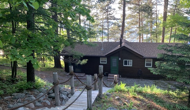 Cabin Nestled Amongst Towering Pines Bluff Overlooking nMain Body of Woman Lake