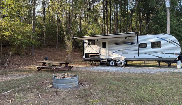 Camper in country setting beside water, near Burning Star Wildlife area
