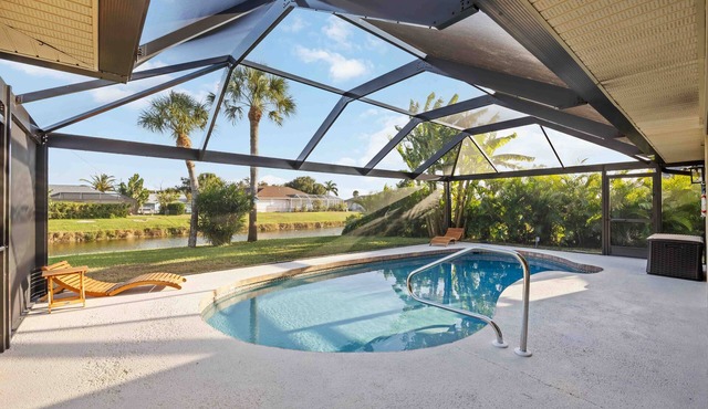 Canal-Front home with Private Lanai Pool & Outdoor TV. Near Gulf Beaches & Golf