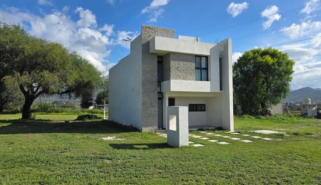 Casa Olivo with double height living room, surrounded by a large garden.