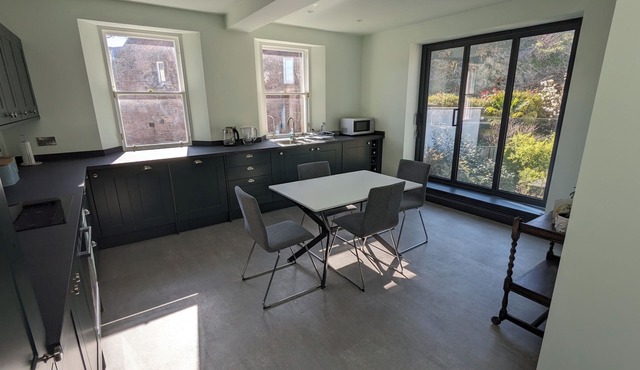 Central holiday home with pretty, sunny garden, moments from the station, golf course and beach.