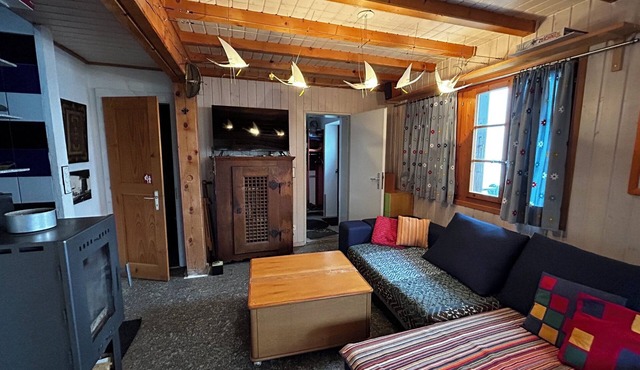 Chalet for 4 people: Living room with wood stove - kitchen with dishwasher and Nespresso coffee mach