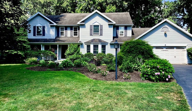 Charming, comfortable and spacious Pittsford home on a pond.