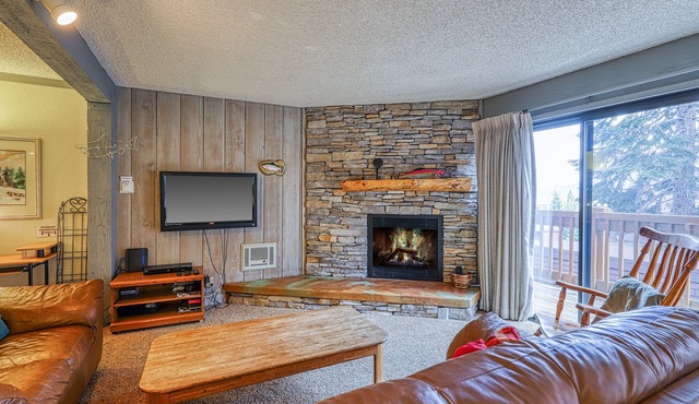 Charming condo with a hot tub, sauna, balcony, deck, game room, & gas fireplace