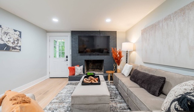 Charming cottage entrance with cozy curb appeal, nestled in a peaceful and green setting.