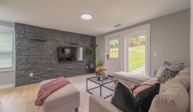 Charming entry and spacious back deck surrounded by nature, perfect for a peaceful getaway.