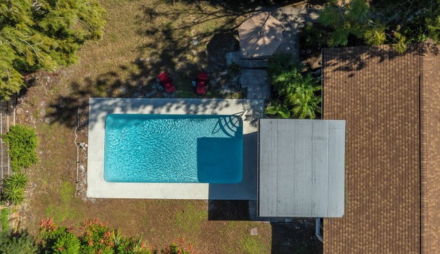 Charming Florida bungalow with pool and fenced-in yard.