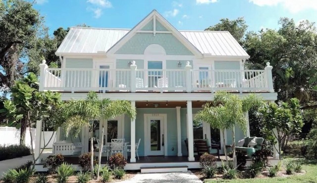 Charming historic Little Blue House with a water view.