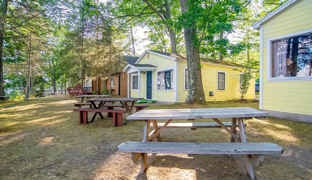 Charming lakefront cottage with large yard, dock, & fire pit - close to downtown