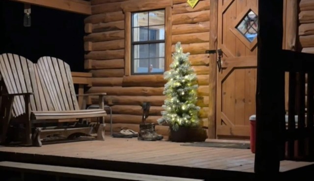 Charming one-room cabin retreat with private bath, kitchenette and log gazebo.
