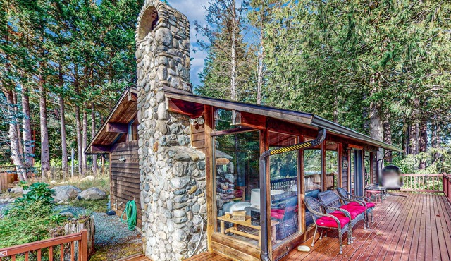 Charming riverfront cabin with hot tub, deck, mountain views and W/D