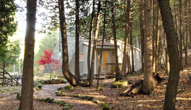Charming updated A-frame home nestled in the woods adjacent to Kimberley Creek.