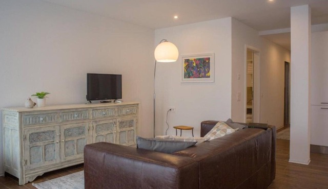 Chestnut apartment surrounded by greenery