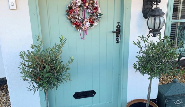 Chocolate box thatch cottage with bell tent