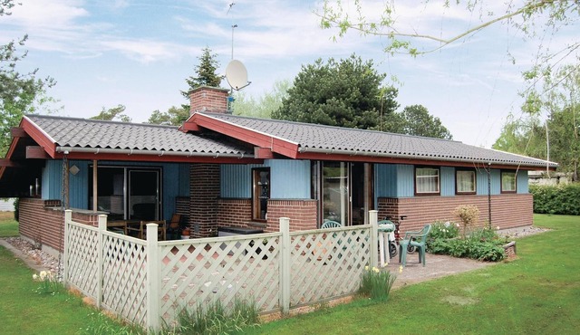 Classic, practically furnished brick vacation home with inviting, fenced terraces and situated on be
