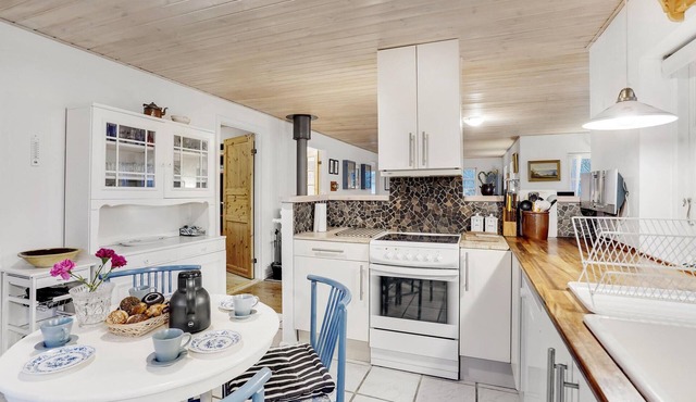 Classic vacation home with inviting eat-in kitchen, wood-burning stove, TV room and 3 bedrooms.