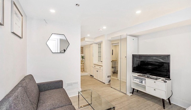 Clean, white, bright and close to Woodbine subway