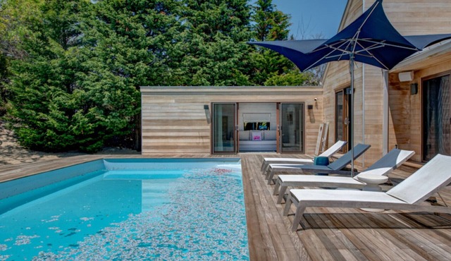 Coastal-style home with private pool, open-floor plan, ample natural.