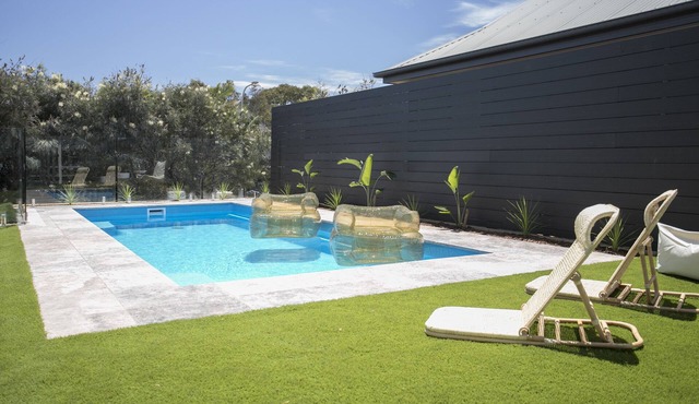 Coastal Vibe & Pool. Nestled halfway between the beach & shops.