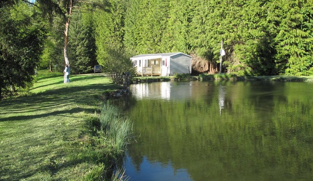 Comfortable mobile home with terrace on the edge of fishing ponds; small boat.