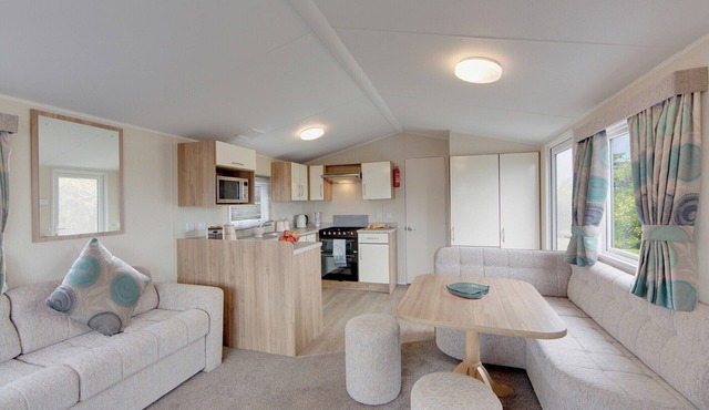 Contemporary caravan with one double with TV, and two twin.