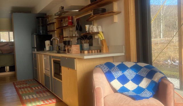 Contemporary shipping container home atop a scenic knoll in Rochester, Vermont.