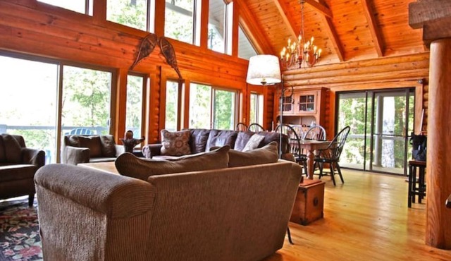 Cool off in the mountains! Enjoy a real log home with endless views .