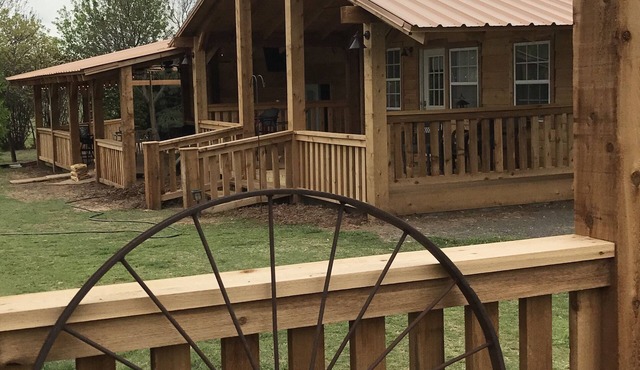 Cottage is tucked away among trees and a small vineyard.