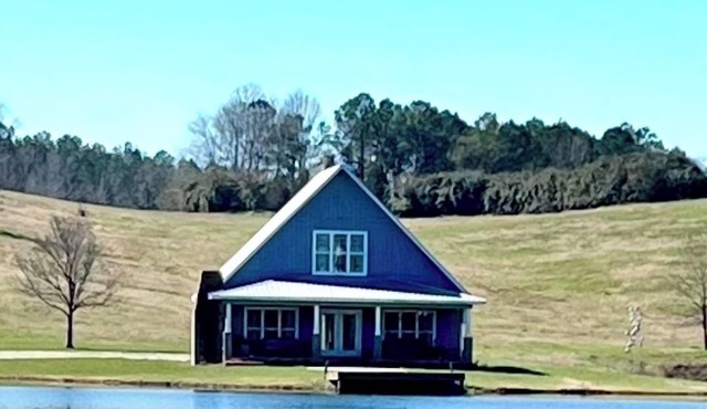 Cottage nestled on 75 acres with beautiful views and 14 acre stocked lake.