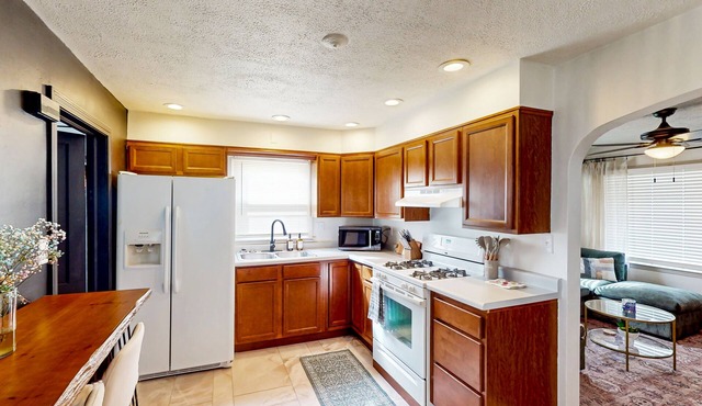 Cottage with front porch, fenced yard, washer/dryer, & AC - convenient location