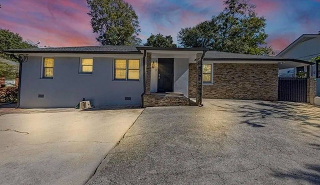 Cozy 2 BR suite with kitchenette, brick accent & comfortable living