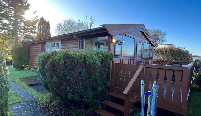 Cozy cabin, nestled on a mountainside with picturesque views.