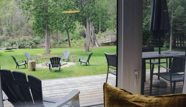 Cozy cabin on a river with an outdoor wood burning sauna and firepit