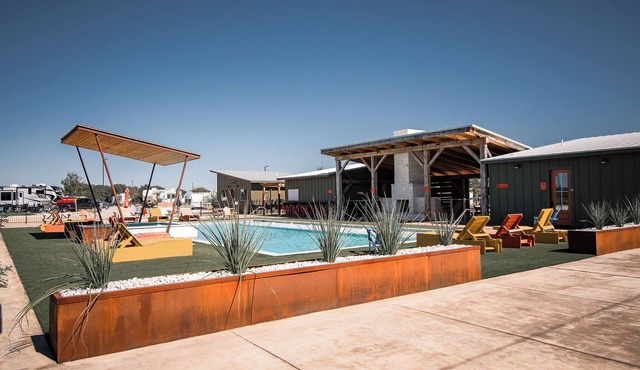 Cozy cabin with queen bed, full kitchen, and refreshing walk-in shower.